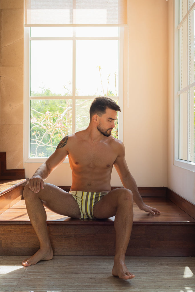 Discover Smithers' newest offering: an eye-catching striped yellow swimsuit showcased on a youthful and athletic male model, making a splash this summer.