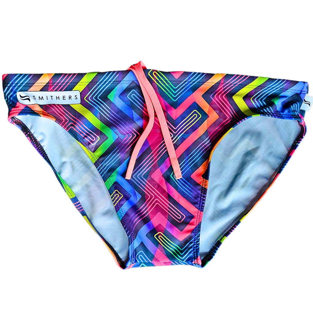 Front view of Smithers men's swimwear 'Rhapsody,' showcasing classic swim briefs silhouette with a striking neon drawcord accentuating the waist. The design features a sleek black base adorned with geometric rainbow accents, embodying the spirit of Pride and celebration.