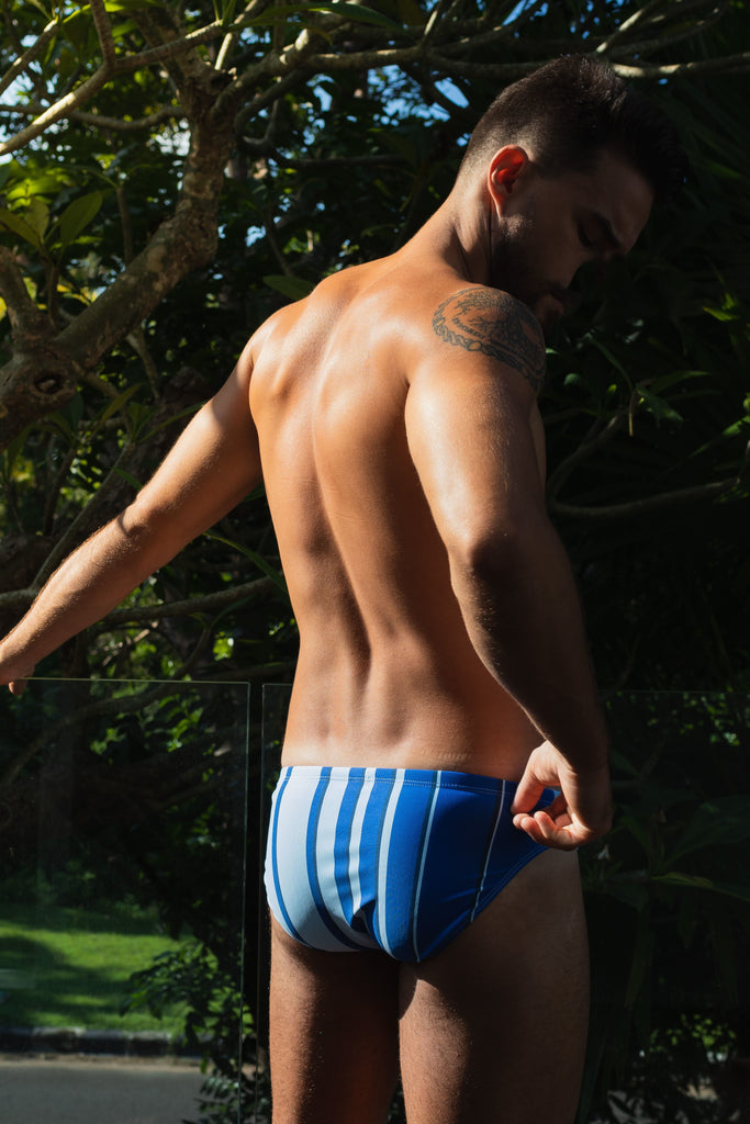 Smithers' latest release: a vibrant striped blue swimsuit modelled by a young, athletic man.